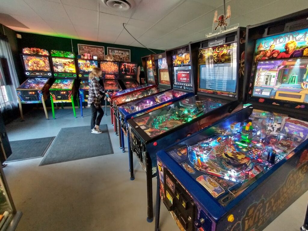 An array of brightly colored, lit up pinball machines at SS Billiards in Hopkins, MN