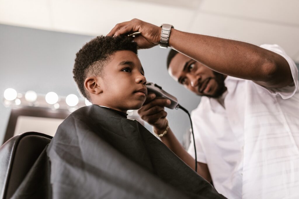 Man gives child a clipper cut